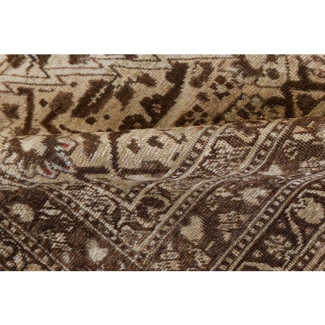 An early 20th century antique Tabriz rug from Northwest Persia, the abrashed sand field with a feathery leaf, flowerhead,...