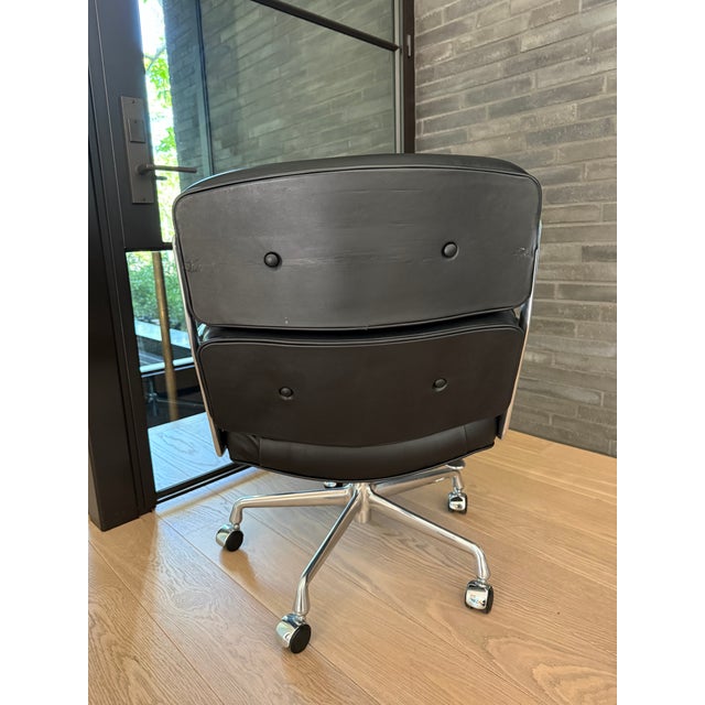 Herman Miller Eames Time Life Office Chair in black leather with a polished chrome frame and base. Originally designed by...
