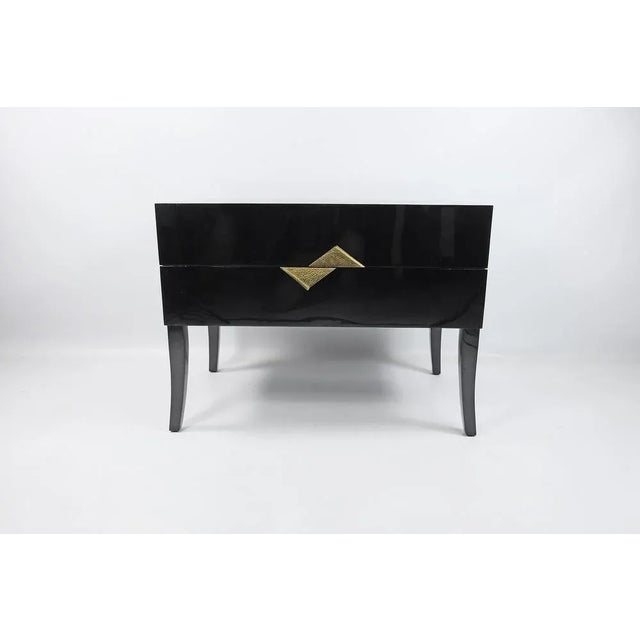 Bedside tables made of black marquetry with casted brass handles. The tables have 2 drawers. Stamped by Maker