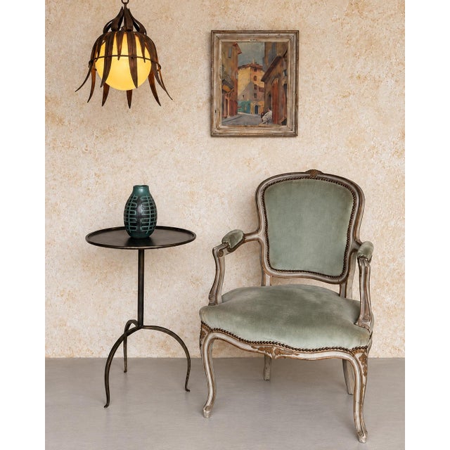 Recently handcrafted in Spain using traditional ironworking techniques, this elegant drinks table features a round top...