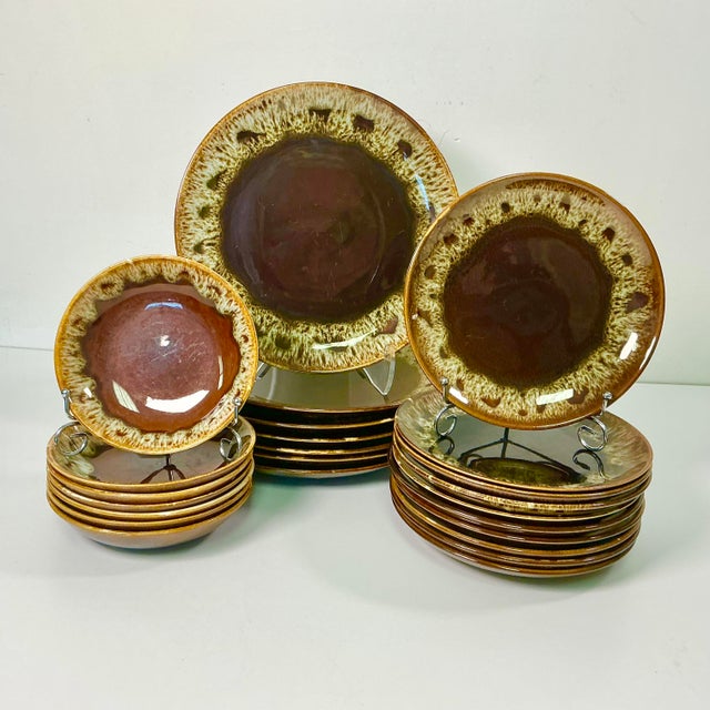 A wonderful dinnerware set from the 1980s featuring a studio pottery lava drip design on brown glazed pottery. The set has...