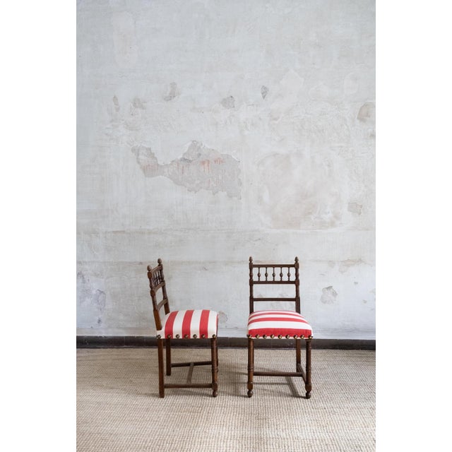Set of six wooden chairs dating from the mid-20th century. The wooden frames feature turned legs and decorative details,...