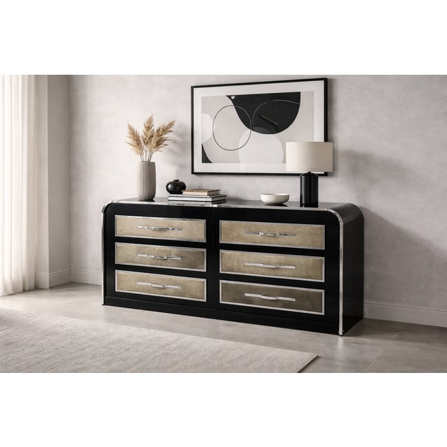 A six-drawer chest of drawers in black lacquered wood with a frame featuring soft lines and rounded corners, typical of...