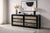 A six-drawer chest of drawers in black lacquered wood with a frame featuring soft lines and rounded corners, typical of...