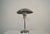 Vintage Art Deco table lamp for sale. It's made of stainless steel with aluminum brass accents, and has a glass diffuser...