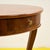 This charming round wooden table is a true design piece that combines functionality and style. Featuring a finely veneered...