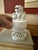 A beautifully sculpted white porcelain covered incense burner topped with a traditional foo dog, also known as a guardian...