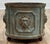 Antique cast iron planter featuring lion heads to faces and three exaggerated ball feet. Heavy weight. Hole in the bottom...