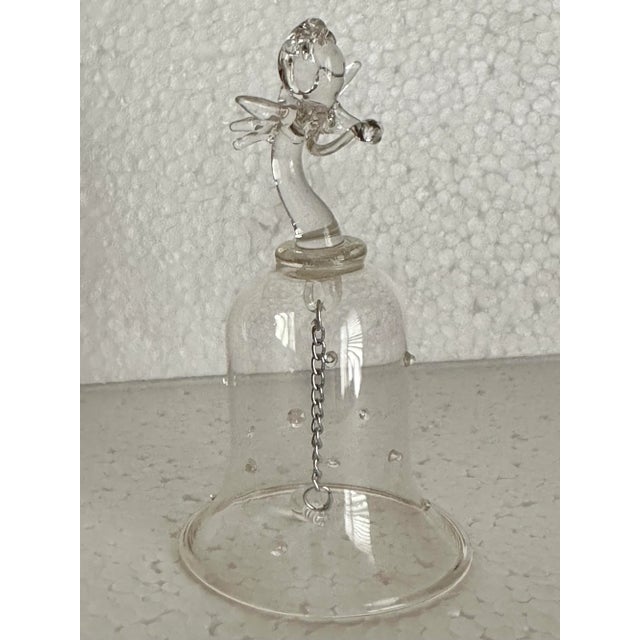 This beautiful glass bell topped with a delicate angel is a charming collectible dinner bell. 2” x 4”.