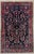 Antique hand-knotted rug from the Nahavand region of western Iran, featuring a detailed tree-of-life design on a deep navy...