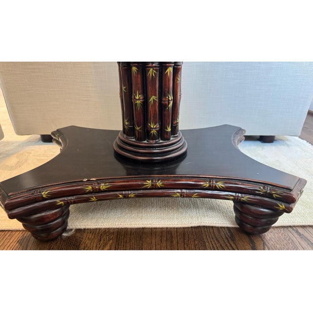 This elegant mid-century accent table features faux-bamboo carved detailing and a rich tortoiseshell-style lacquer finish....