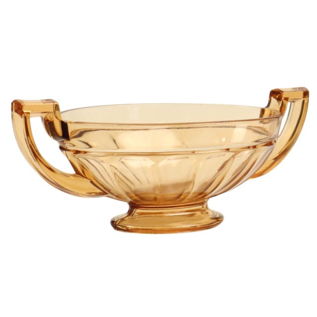 Art Deco fruit bowl or centerpiece made of amber-colored pressed glass—specifically the oval version of the "Noémie"...