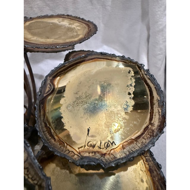 A striking signed Brutalist tabletop sculpture dating to the mid-20th century, featuring an organic botanical composition...