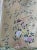 A sophisticated hand painted champagne silver wallpaper featuring delicate birds, blooming flowers, and graceful botanical...