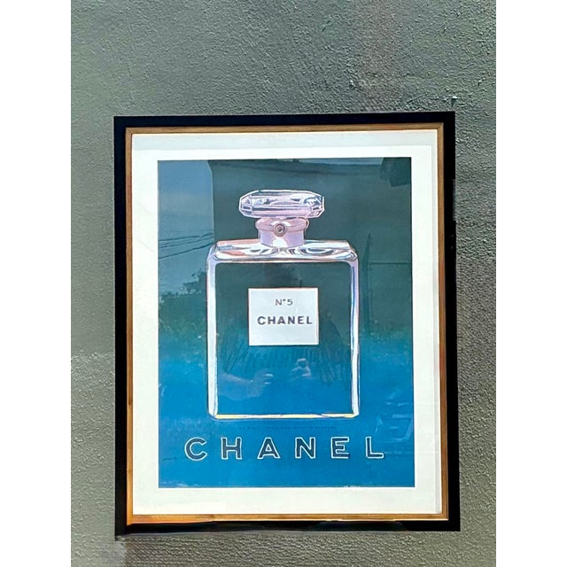 This striking framed poster is a celebrated intersection of high fashion and Pop Art, paying homage to the legendary...