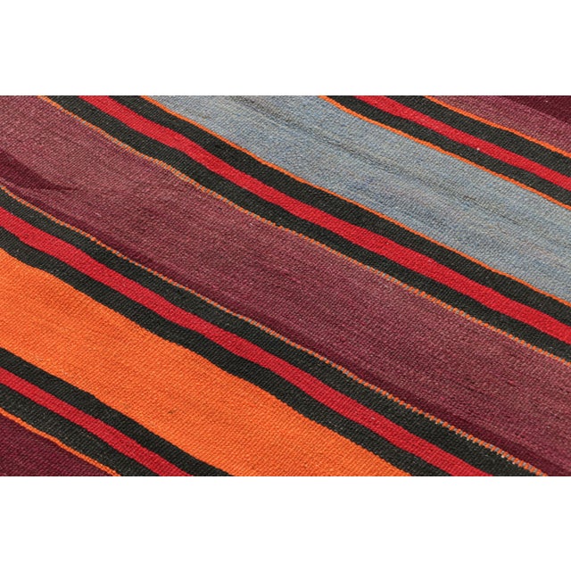 Made with handwoven wool in Persia circa 1950-1960, this 5x9 vintage Shahsavan Kilim is a particularly bright and sought-...