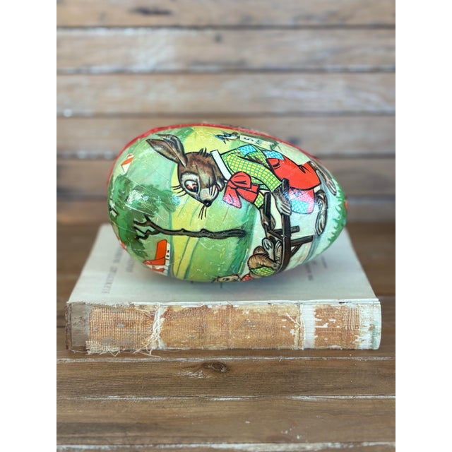 This charming vintage Easter egg box is crafted from papier-mâché and features a colorful hand-decorated rabbit scene,...