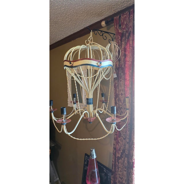 Chandelier in the shape of a hot air balloon, mid-20th century. A whimsical structure with arched metal rods forming an...