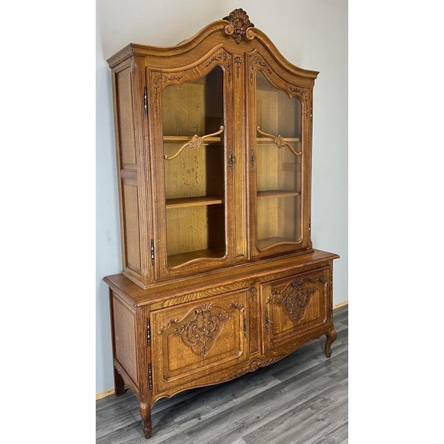 Elegant Vintage French Louis Bookcase This elegant vintage French Louis bookcase is a beautifully crafted oak display...