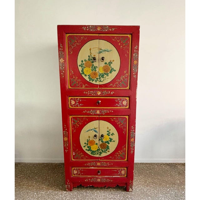 Great asian, chinese wooden cabinet in a red/orange color with a painted decor of flowers and birds at the front. sides...