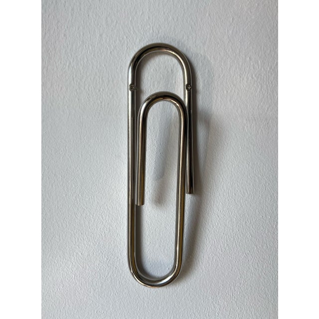 An original wall-mounted coat hanger made of chromed steel rod, shaped with a unique line that recalls the essential shape...