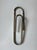 An original wall-mounted coat hanger made of chromed steel rod, shaped with a unique line that recalls the essential shape...
