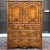 A late 20th century Ethan Allen Country French collection solid birch highboy door dresser having a large 2 door cabinet...