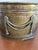 Vintage brass tone oval planter/cachepot featuring elegant rope swag embellishments and a beautifully aged patina. This...