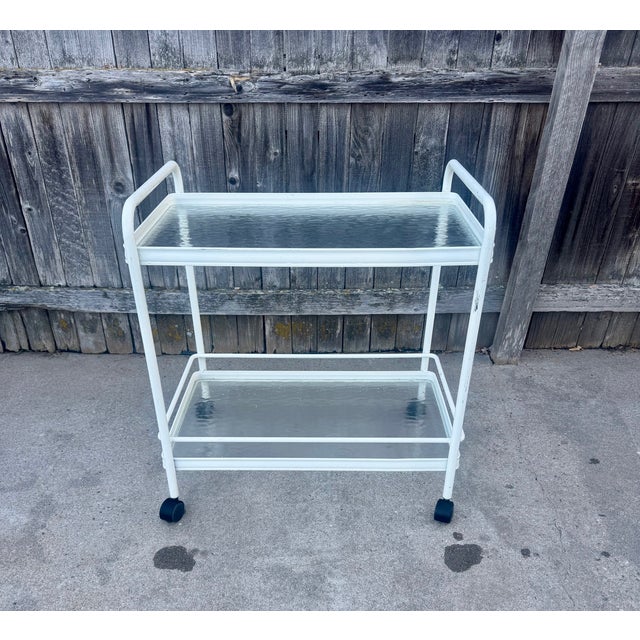 Classic, vintage Mid Century Brown Jordan "Tamiami" bar cart. Cast aluminum with two glass shelves and smooth-rolling...