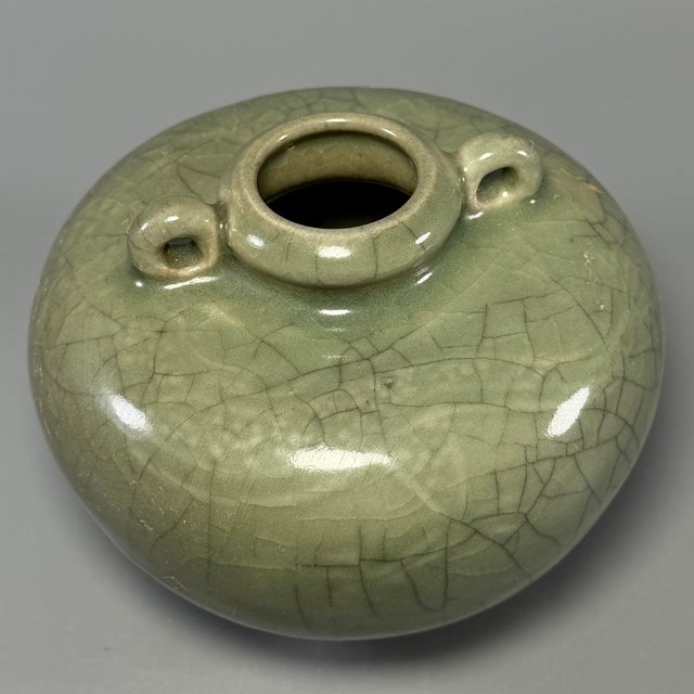 Fine antique Chinese celadon globular jar. Rounded bulbous body with two small loop handles at the shoulder, subtle carved...
