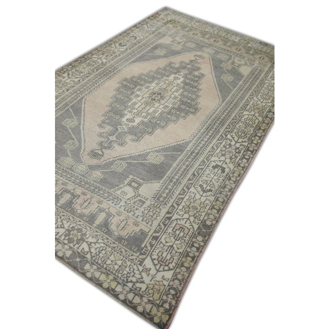 Introducing a one-of-a-kind vintage Turkish hand-knotted wool rug, carefully crafted by skilled artisans using traditional...