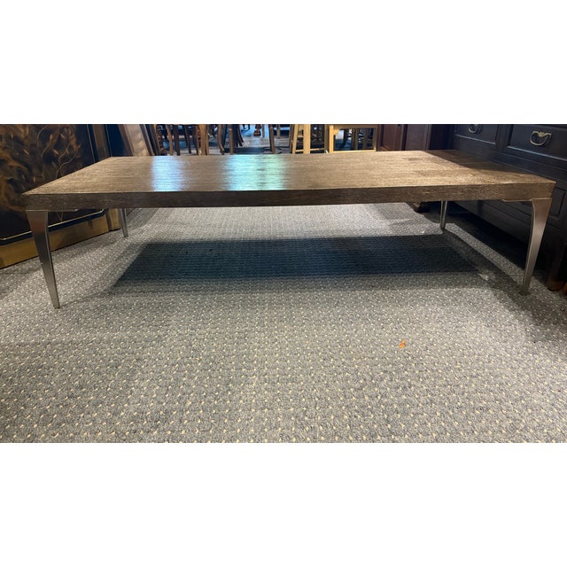 A sleek and substantial coffee table from the TA Studio collection by Theodore Alexander. Designed with modern...