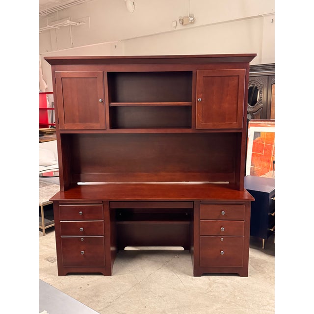 Design Plus Gallery presents a Desk + Hutch from Stuart David. This piece is rendered in a cherry-toned wood veneer with a...