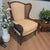 Bring a touch of refined Hollywood Regency flair to your space with this vintage wingback bergere chair manufactured by...