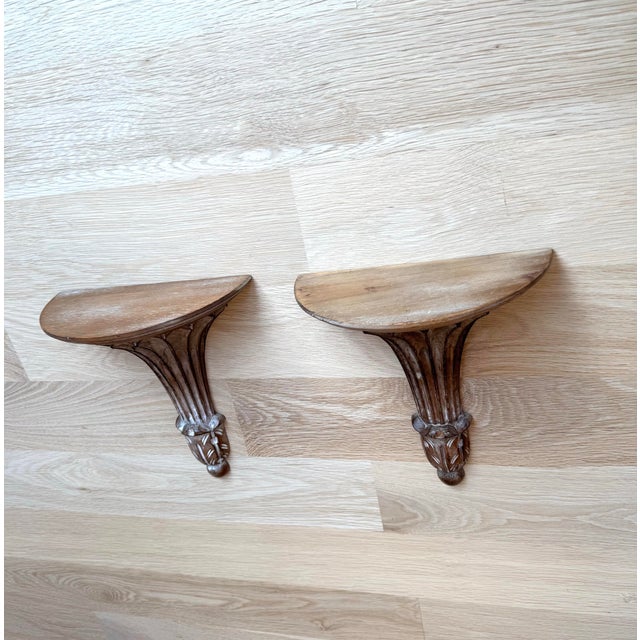 An elegant pair of vintage carved wood wall brackets by Decorative Crafts, Inc., each retaining its original company label...