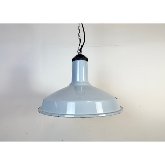 Industrial light blue ( grey ) enamel factory pendant light made in United Kingdom during the 1960s. White enamel inside...