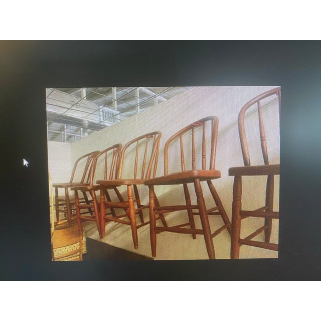 Antique primitive spindle back chair with bow back. Painted with faded red chipped paint. Worn and authentic condition.