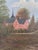 This original vintage oil painting, created around 1930, shows a large manor house beside a lake, surrounded by trees and...