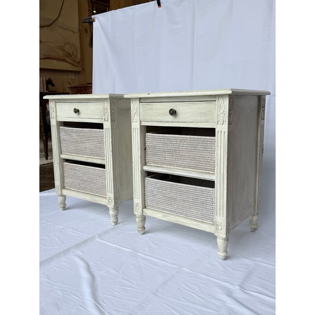 This is a charming pair of French inspired nightstands, finished in a softly distressed painted surface that lends warmth...