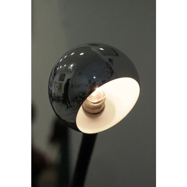 Table lamp of Italian production from the 70s in industrial style, consisting of a chromed metal base as well as the...