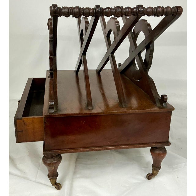 Fine antique English mahogany Canterbury in Regency style. X-shared top with carved wreath medallion, dovetailed storage...