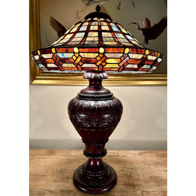 Substantial 19th Century Antique Hand Carved Mahogany Wood Table Lamp with a Tiffany Style Stained Glass Shade. The Dark...
