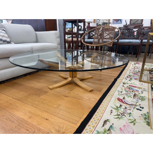 Stunning four foot round glass top cocktail table from Denmark with sculptural Scandinavian Modern base.