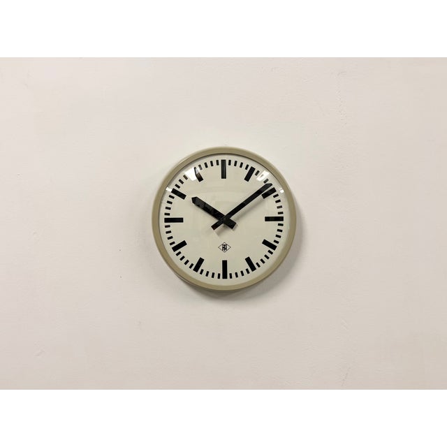 Wall clock produced by TN Telefonbau und Normalzeit in Germany during the 1960s. It features a grey bakelite frame, a...