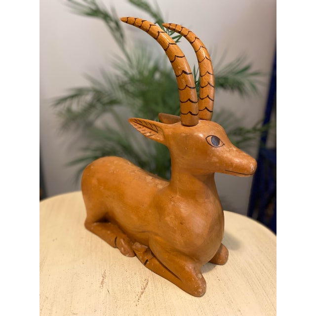 A large Antelope Gazelle wood sculpture with aged patina. The horns come out maybe for easier shipping:) A beautiful size...