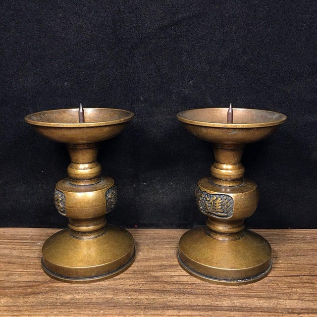 Elevate your tablescape or meditation space with this elegant pair of brass candle holders. Each candlestick features a...