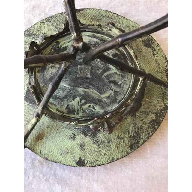 This unique 1920s Copper Stamped Dish Or Disc With Patina On Copper Faux Bamboo Stand has a variety of uses as well as...