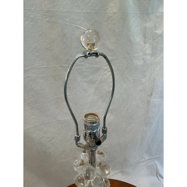 The Arteriors Lucite Bubble Table Lamp is a modern and stylish lighting fixture perfect for a bedroom setting. This lamp...