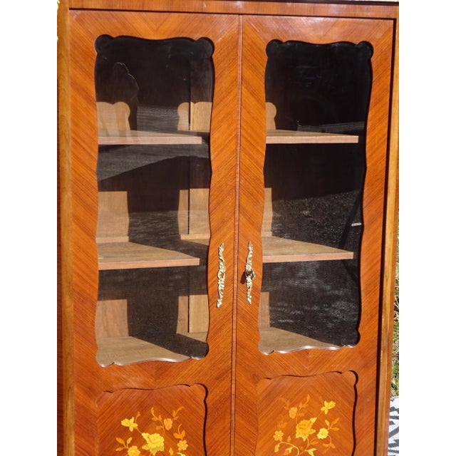 Antique Louis XV style display cabinet with decorative bronze mounts and a marble top. Medium-sized, shallow bookcase-...
