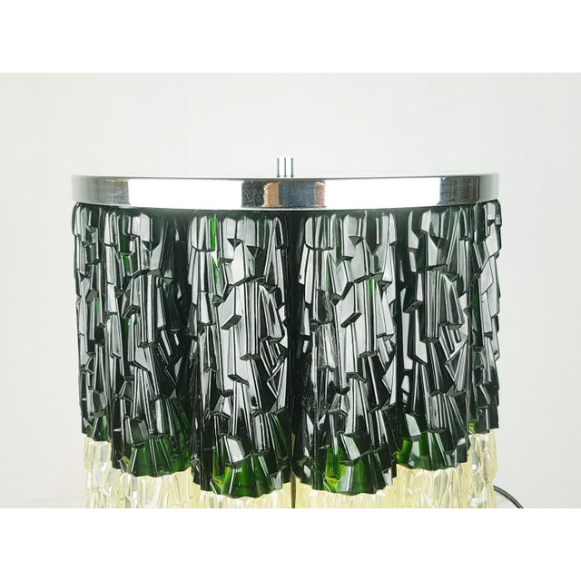 This large table lamp was produced in Italy in the 1960/70s. It is made from a doble row of plastic cylinders in yellowed...